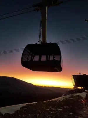 a ski lift at the top of a mountain at sunset at Lodge Visnes Stryn in Stryn