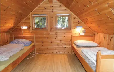 a log cabin with two beds in it at 3 Bedroom Nice Home In Vallavik in Vangsbygd