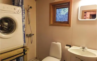 a small bathroom with a toilet and a sink at 3 Bedroom Nice Home In Vallavik in Vangsbygd