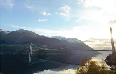 a bridge over a body of water with mountains at Gorgeous Home In Vallavik With Wifi in Vangsbygd
