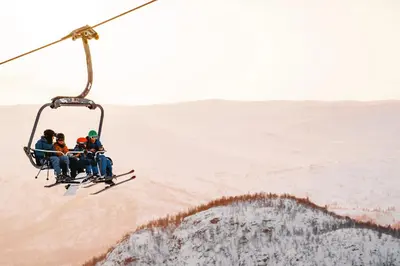 a group of people riding a ski lift at Hovdestøylen in Hovden