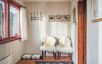 two white chairs sitting in a room at Three-Bedroom Holiday Home In Sjusjoen in Sjusjøen