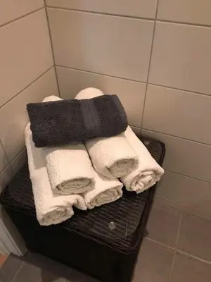 a pile of towels sitting on a rack in a bathroom at Førde in Førde