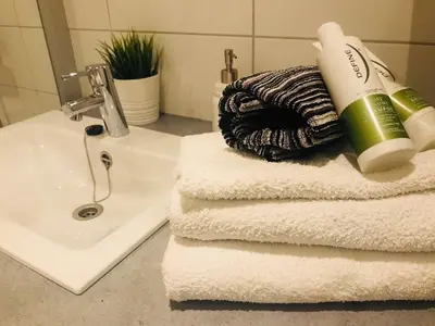 a pile of towels with a blow dryer on top of a sink at Førde in Førde
