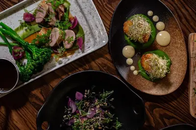 two plates of food on a wooden table at Quality Hotel Prinsen in Trondheim