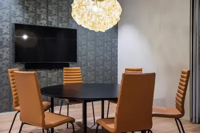 a dining room with a black table and chairs at Quality Hotel Prinsen in Trondheim