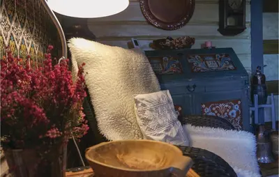 a couch with pillows and a table with a lamp at Three-Bedroom Holiday Home In Sjusjoen in Sjusjøen