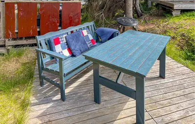 a picnic table and a blue bench on a wooden deck at Three-Bedroom Holiday Home In Sjusjoen in Sjusjøen