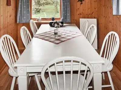a white dining room table with white chairs at 8 person holiday home in FINNÅS in Vordnes