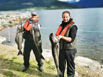a man and a woman holding a bunch of fish at 5 person holiday home in EIDSVÅG in Eidsvåg