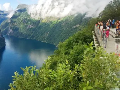 a group of people standing on a bridge over a lake at 5 person holiday home in EIDSVÅG in Eidsvåg