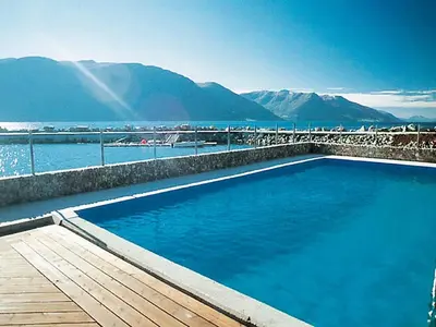 a swimming pool with a view of the water at 6 person holiday home in EIDSVÅG in Eidsvåg