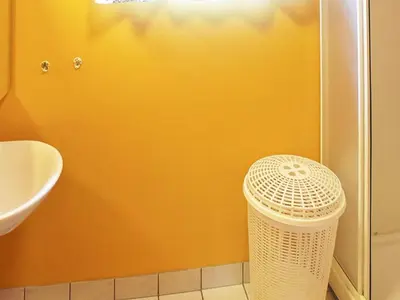 a bathroom with a trash can in the corner at 4 person holiday home in Måndalen in Sæbø