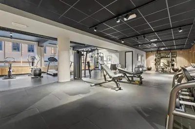 a gym with treadmills and cardio equipment in a building at Home Hotel Astoria in Hamar