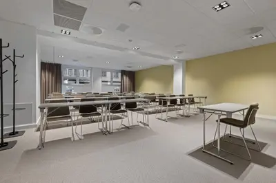 a conference room with tables and chairs in it at Home Hotel Astoria in Hamar