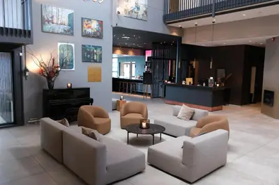 a lobby with couches and chairs and a piano at Ørland Kysthotell in Brekstad