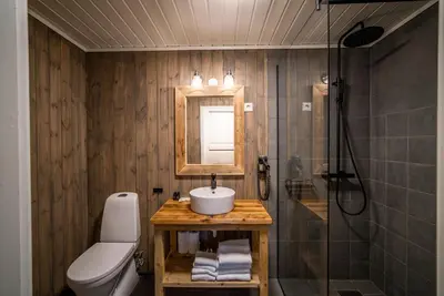 a bathroom with a sink and a shower and a toilet at Hustadvika Havhotell - by Classic Norway Hotels in Farstad