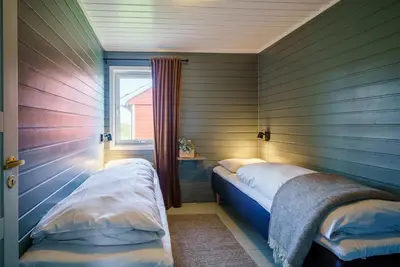 a room with two beds in a room with a window at Hustadvika Havhotell - by Classic Norway Hotels in Farstad