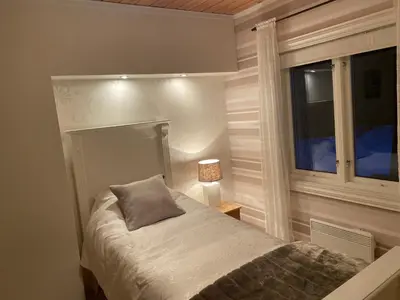 a small bedroom with a bed and a window at Nordbø Pensjonat in Hjartdal