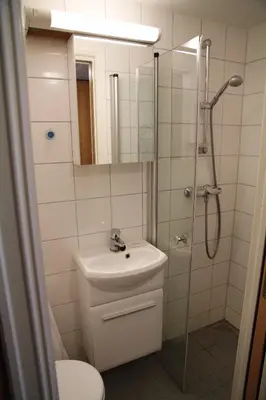 a bathroom with a toilet and a sink and a shower at Førde Sommarhotell in Førde