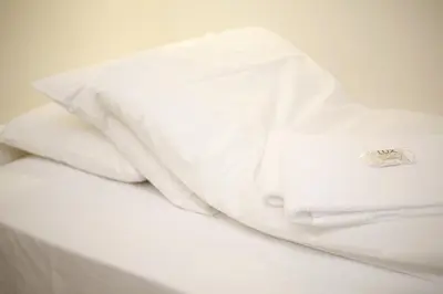 a white shirt sitting on top of a bed at Førde Sommarhotell in Førde