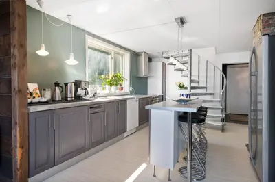 a kitchen with gray cabinets and a kitchen island at Private House & Bungalow by the sea in Trondheim