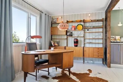 a kitchen with a wooden desk and a table at Private House & Bungalow by the sea in Trondheim