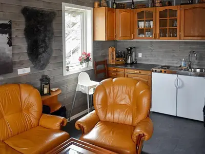 a kitchen with two leather chairs and a counter top at 8 person holiday home in Urangsvåg-By Traum in Ervik