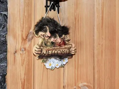 a sign on a wooden wall with two skeletons on it at 6 person holiday home in Rennebu-By Traum in Sundset