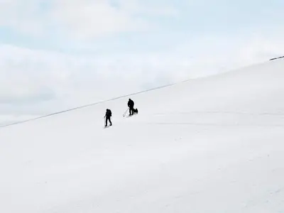 two people skiing down a snow covered slope at 6 person holiday home in Rennebu-By Traum in Sundset