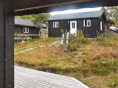 a view of a house and a yard with a building at 6 person holiday home in Rennebu-By Traum in Sundset