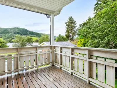 a wooden porch with a view of the water at 8 person holiday home in VÅGLAND-By Traum in Vågland