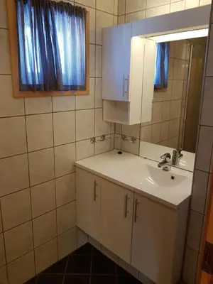 a bathroom with a sink and a mirror at Solstua Three-bedroom Cottage in Geilo
