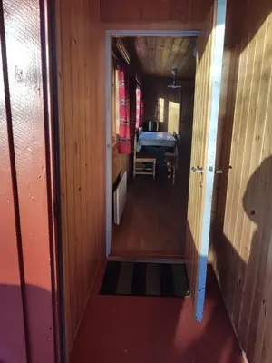 a hallway leading into a room with a door at Nybu Two-bedroom cottage in Geilo