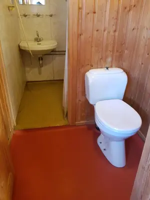 a bathroom with a white toilet and a sink at Nybu Two-bedroom cottage in Geilo