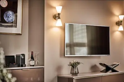a living room with a flat screen tv on a wall at Opus 16, a Member of Small Luxury Hotels in Bergen