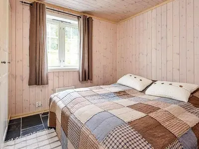a bedroom with a bed and a window at 11 person holiday home in Fåvang-By Traum in Favang