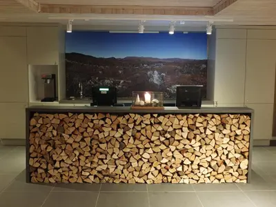 a bar with a pile of wood behind it at Hovden Fjellstoge in Hovden