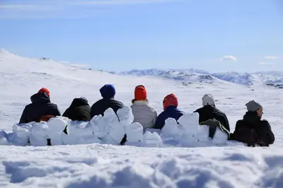 a group of people sitting in the snow at Hovden Fjellstoge in Hovden
