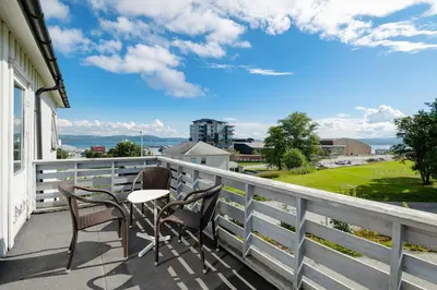 a patio with two chairs and a table on a balcony at Brekstad Gjestehus AS in Brekstad