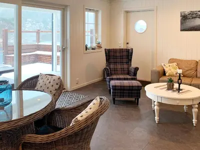 a living room with chairs and a table and a tablektop at 8 person holiday home in Urangsvåg-By Traum in Ervik