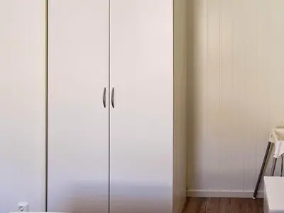 a white cupboard in a room with white walls at 8 person holiday home in Urangsvåg-By Traum in Ervik