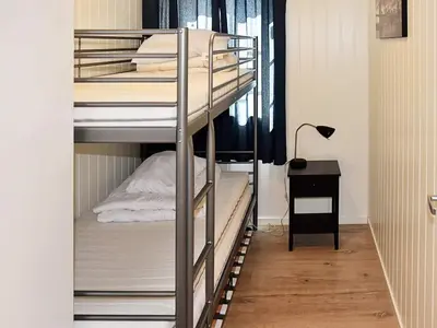 a room with two bunk beds and a desk at 8 person holiday home in Urangsvåg-By Traum in Ervik