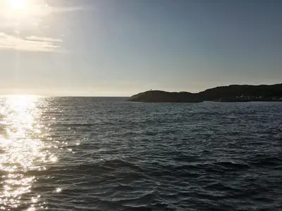 a large body of water with the sun shining on it at 8 person holiday home in Urangsvåg-By Traum in Ervik
