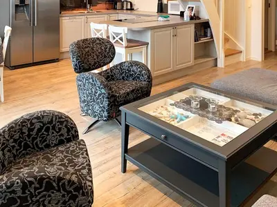 a living room with two chairs and a table at 8 person holiday home in Urangsvåg-By Traum in Ervik