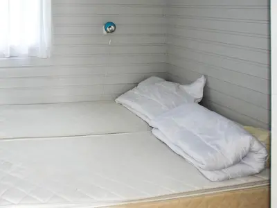 a bed in a room with white sheets and pillows at 5 person holiday home in Selje-By Traum in Selje