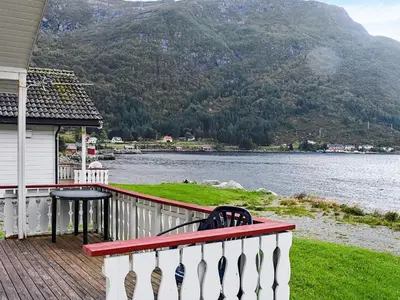a house balcony with a view of a lake and mountains at 5 person holiday home in Selje-By Traum in Selje