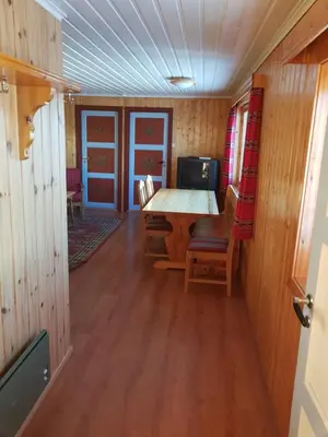 a dining room with a table and chairs at Knutebu Two-Bedroom Cottage in Geilo