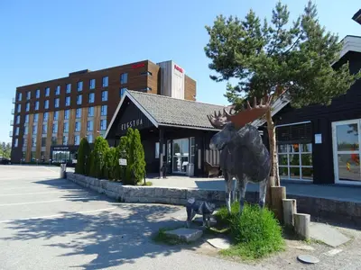 a statue of a moose standing next to a tree at Thon Hotel Elgstua in Elverum