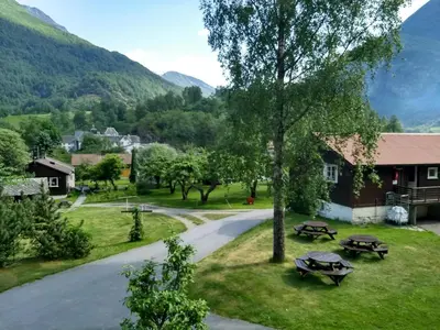 a view of a village with mountains in the background at Flåm Hostel & Cabins in Flåm